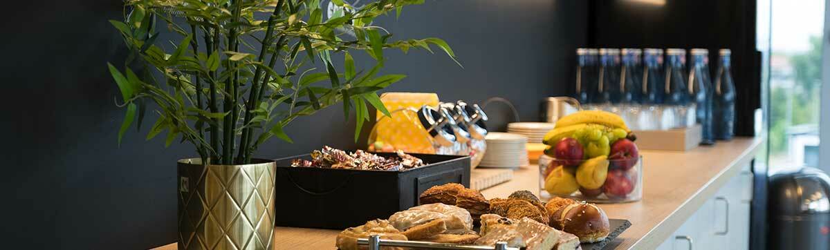 A selection of fruit and pastries on a sideboard